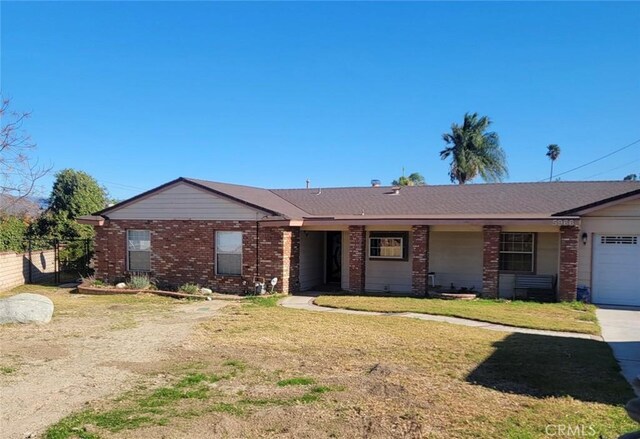 single story home with a front yard and a garage