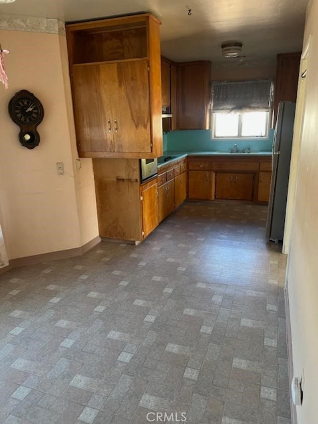 kitchen with stainless steel refrigerator and sink