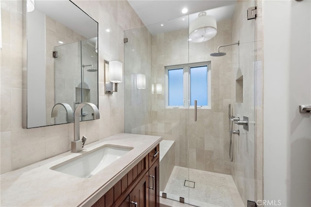 bathroom featuring vanity and a shower with door