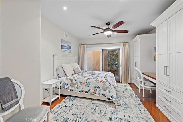 bedroom featuring hardwood / wood-style floors, access to outside, and ceiling fan