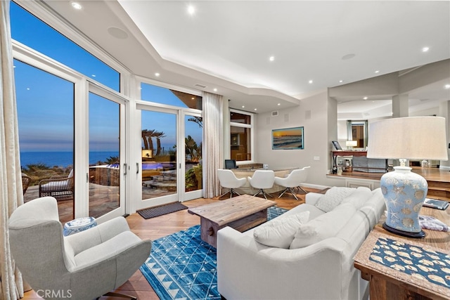 living room featuring a water view and light wood-type flooring