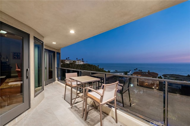 balcony at dusk with a water view