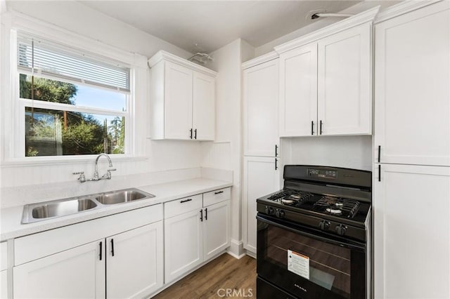 kitchen with white cabinets, black gas range, plenty of natural light, and sink