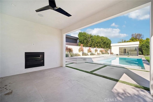 view of swimming pool with a fenced in pool, a patio, fence, and ceiling fan