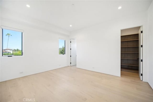 spare room with light wood-style flooring and a wealth of natural light