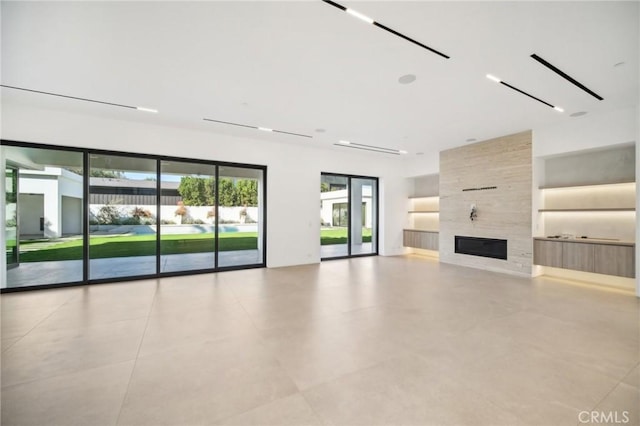 unfurnished living room with a tile fireplace