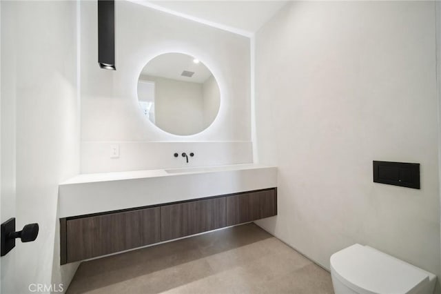 half bathroom with vanity and toilet