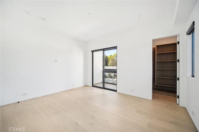 spare room with light wood finished floors