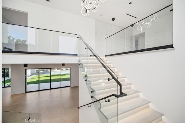 stairs featuring a towering ceiling