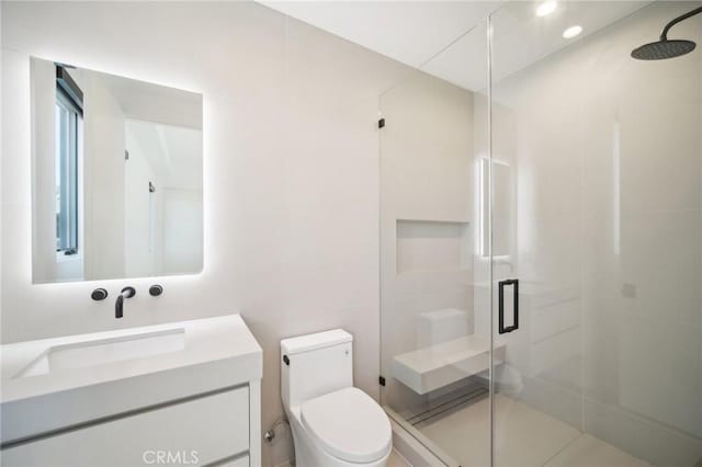 full bathroom with a stall shower, vanity, and toilet