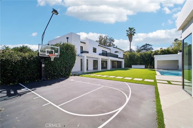 view of sport court featuring basketball court and a yard