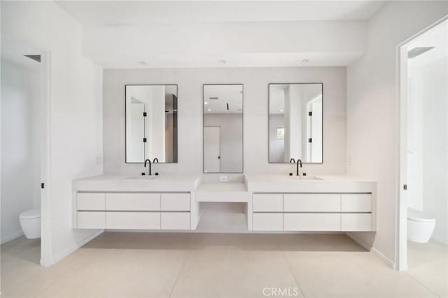 bathroom featuring toilet, tile patterned floors, and vanity