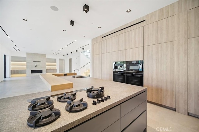 kitchen featuring light countertops, modern cabinets, and a sink