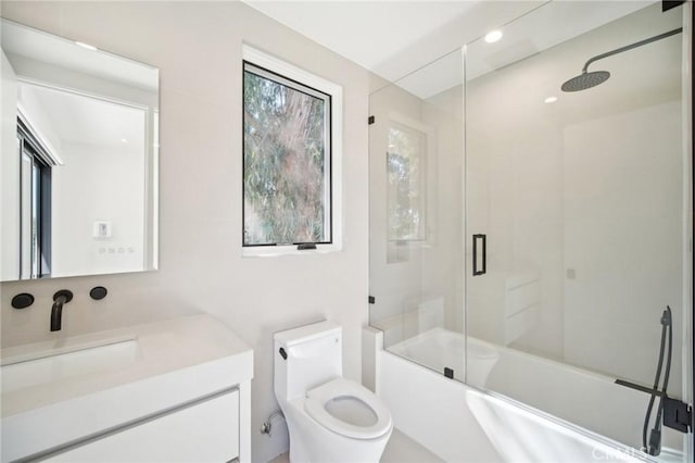 bathroom featuring shower / bath combination with glass door, vanity, and toilet