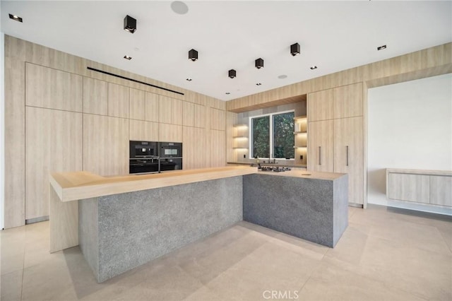 kitchen with light brown cabinetry, light countertops, and modern cabinets