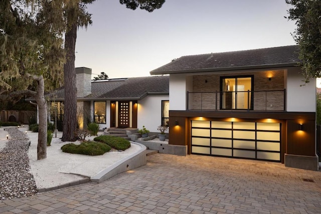 view of front of home featuring a balcony and a garage