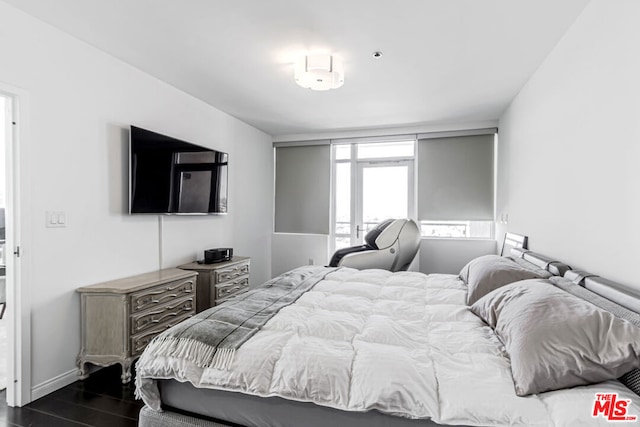 bedroom with dark hardwood / wood-style flooring