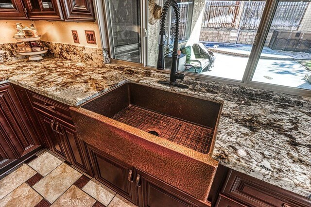 interior space featuring sink and stone countertops