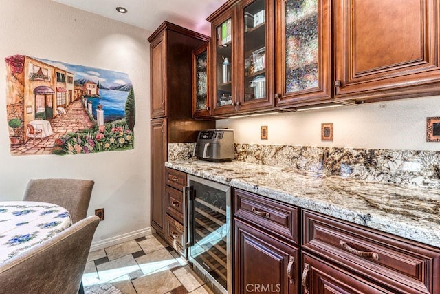 bar featuring beverage cooler, light tile patterned flooring, and light stone counters