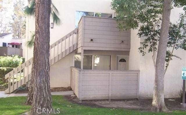 rear view of house featuring stucco siding