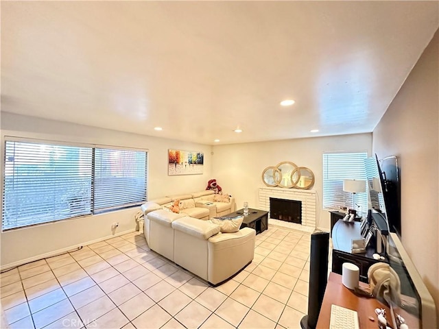 living room featuring recessed lighting, light tile patterned flooring, a fireplace, and baseboards