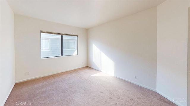 empty room with light colored carpet