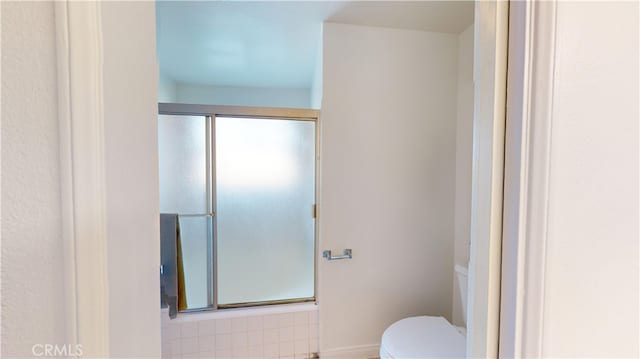 bathroom with an enclosed shower and toilet