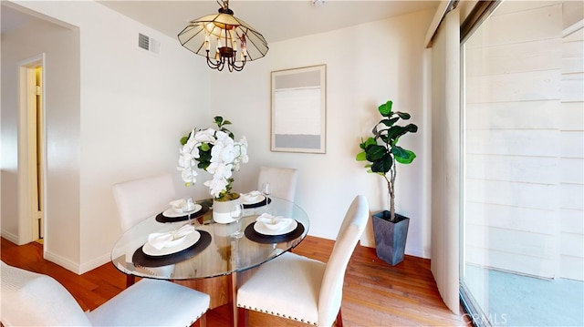 dining room featuring a chandelier and light hardwood / wood-style flooring