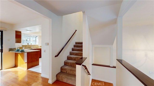 staircase with hardwood / wood-style floors