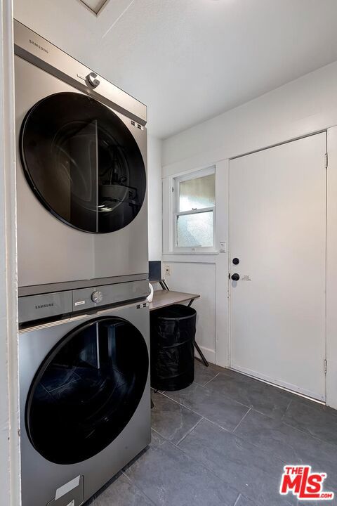 laundry area with stacked washer / drying machine