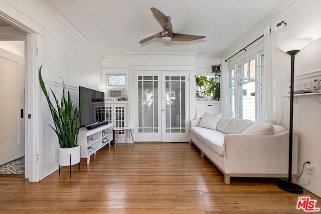 living room with hardwood / wood-style flooring, ornamental molding, french doors, and ceiling fan