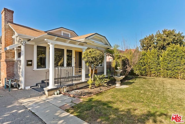 view of front facade with a front lawn and a porch