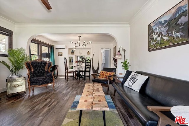 living room featuring dark hardwood / wood-style flooring, a notable chandelier, crown molding, and a wall mounted AC