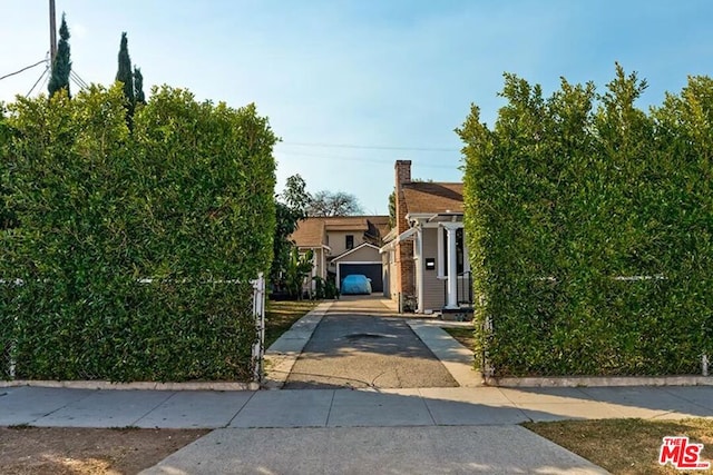 obstructed view of property featuring a garage