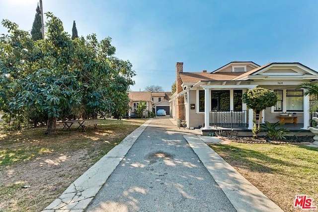 bungalow-style home with a porch and a front lawn