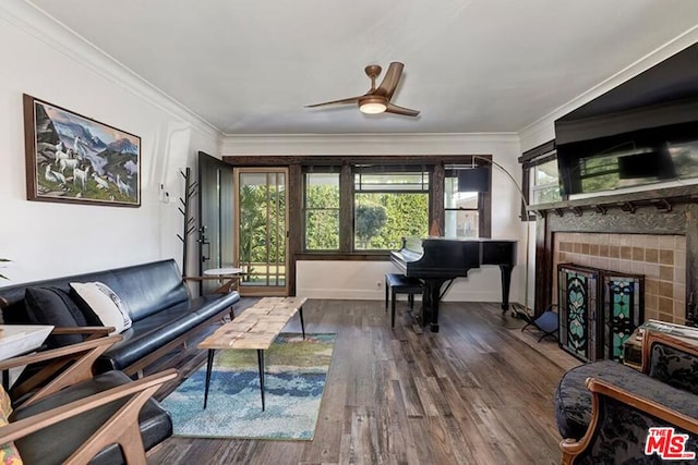 living room with crown molding, dark wood-type flooring, and ceiling fan