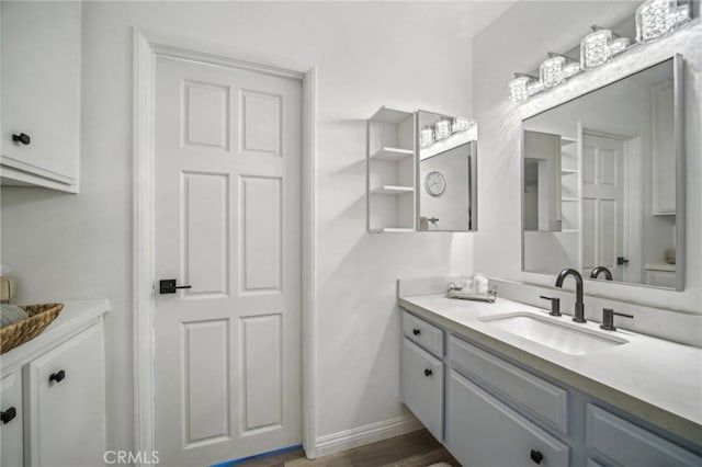 bathroom with vanity and hardwood / wood-style flooring