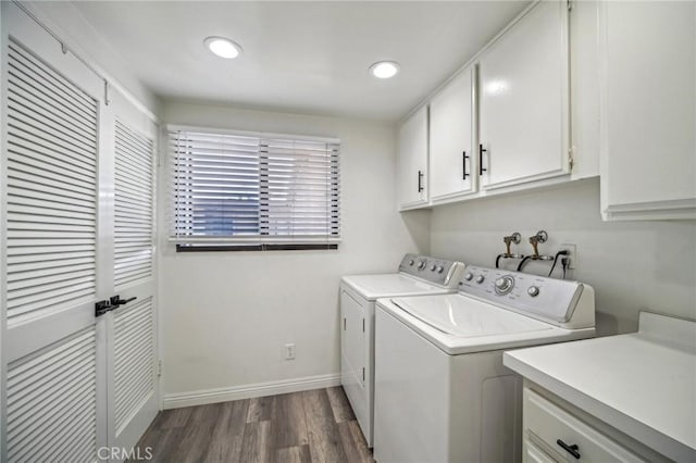 laundry area with cabinets, dark hardwood / wood-style flooring, and separate washer and dryer