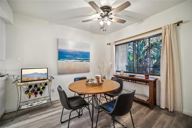 dining room with ceiling fan and hardwood / wood-style floors