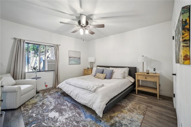 bedroom with ceiling fan and dark hardwood / wood-style flooring