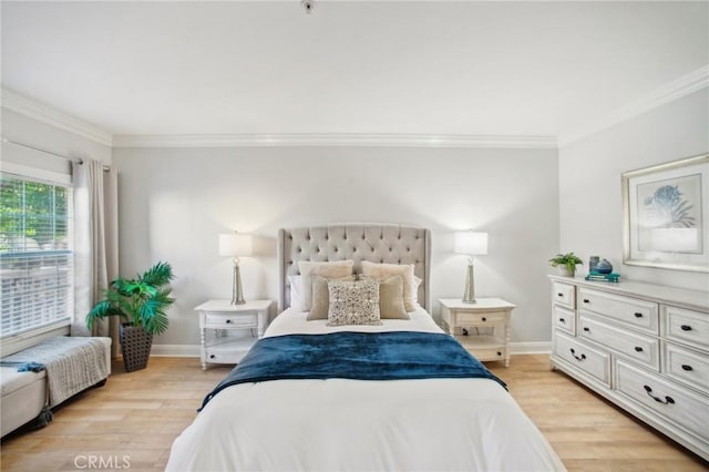 bedroom with light hardwood / wood-style floors and crown molding