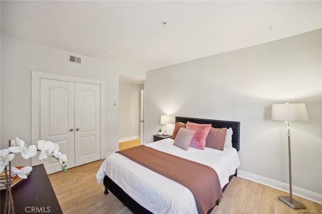 bedroom with a closet and light hardwood / wood-style flooring