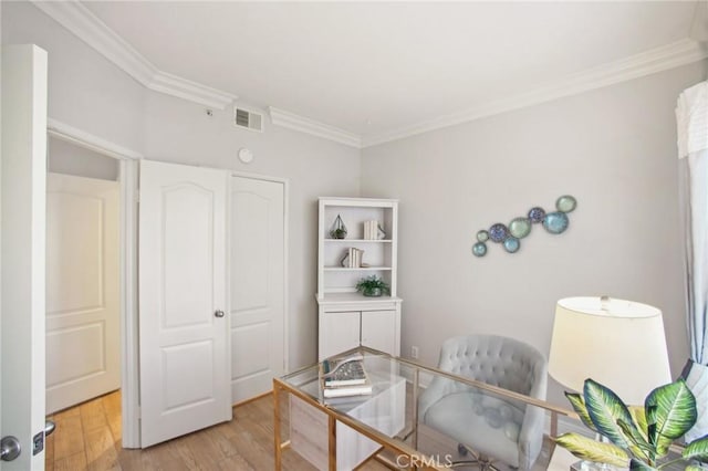 home office featuring light hardwood / wood-style flooring and crown molding