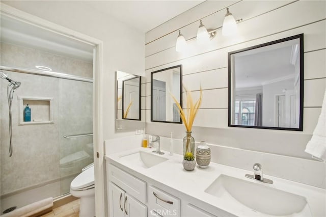 bathroom featuring vanity, toilet, and a shower with door