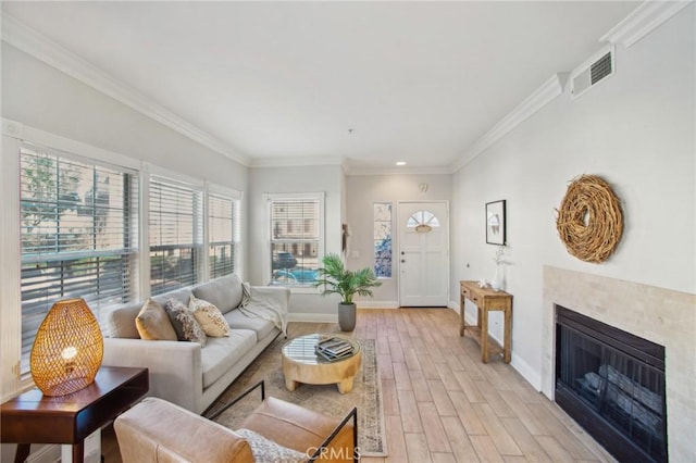 living room featuring crown molding and light hardwood / wood-style flooring