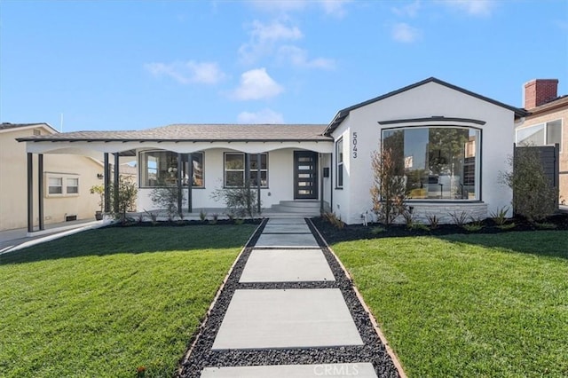 ranch-style house featuring a front yard and a carport