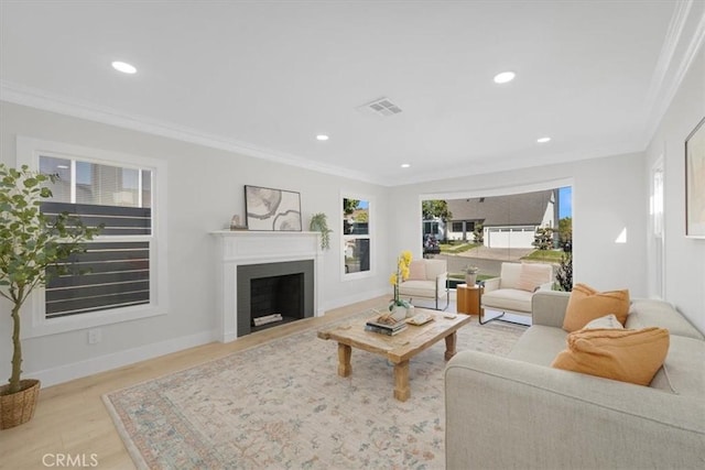 living room with light hardwood / wood-style floors and ornamental molding