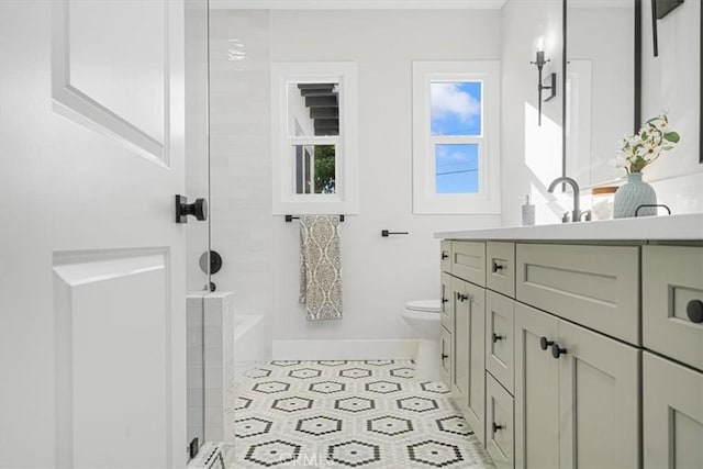 bathroom featuring tile patterned floors, a shower, vanity, and toilet