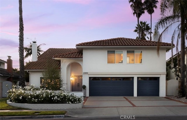 mediterranean / spanish house with a garage