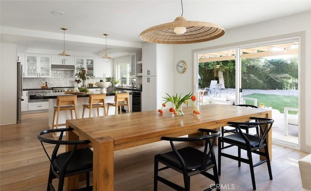 dining space featuring sink and light hardwood / wood-style flooring